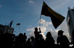 Opponents to Venezuela's President Nicolas Maduro hold a vigil for those killed in street fighting over the past week in Caracas, Venezuela, May 5, 2019.