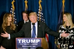 Republican presidential candidate, businessman Donald Trump speaks to supporters during a primary night rally, Tuesday, Feb. 9, 2016, in Manchester, N.H. At his side are his wife Melania Trump, left, and daughter Ivanka Trump, right.