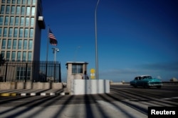 A vintage car passes by the U.S. embassy in Havana, Cuba, March 12, 2019.