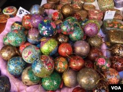 These hand painted ornaments from Kashmir, sold at the Downtown Holiday Market, are made of papier-mâché. (J.Taboh/VOA)