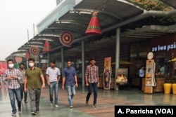 In satellite towns around Delhi, India, which also faces severe pollution, some people ventures out only after wearing masks, Nov. 6, 2016.