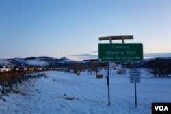 Cars are slowed down by security as they enter the camp at Standing Rock, where thousands have been living in protest of an oil pipeline planned through Native American land (E. Sarai/VOA)