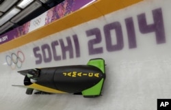 The JAM-1 sled from Jamaica, takes a turn during a training run for the men's two-man bobsled at the 2014 Winter Olympics, Feb. 6, 2014, in Krasnaya Polyana, Russia.