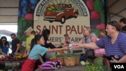 The St. Paul Farmer's Market was alive with transactions on a recent market day, bringing growers of fresh produce together with their customers. (J. Soh/VOA)
