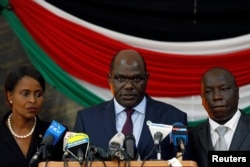Kenyan Independent Electoral and Boundaries Commission (IEBC) chairman Wafula Chebukati (C), flanked by deputy chairman Connie Nkatha (L) and Commissioner Paul Kurgat, addresses a news conference at the Bomas of Kenya, in Nairobi, Kenya, Oct. 25, 2017.