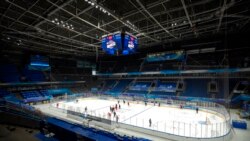 FILE - The China Ice Sports College hockey team practices on the ice during the Experience Beijing Ice Hockey Domestic Test Activity, a test event for the 2022 Beijing Winter Olympics, at the National Indoor Stadium in Beijing, Nov. 10, 2021.