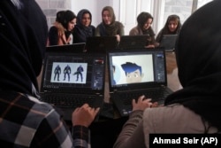 In this Monday, Jan. 22, 2018 photo, Afghan coders practice at the Code to Inspire computer training center in Herat province, western Afghanistan.
