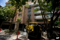 A drill creates a well during water shortages outside the luxury apartment complex in the Campo Alegre neighborhood of Caracas, Venezuela, May 31, 2018.