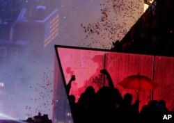 Confetti drops over the crowd as the clock strikes midnight during the New Year's celebration in Times Square as seen from the Marriott Marquis in New York, Jan. 1, 2019.
