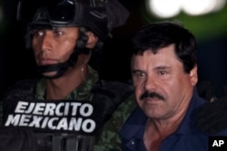 Mexican drug lord Joaquin "El Chapo" Guzman, right, is escorted by soldiers and marines to a waiting helicopter, at a federal hangar in Mexico City, Jan. 8, 2016.