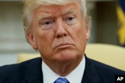 President Donald Trump listens during a meeting with Ukrainian President Petro Poroshenko in the Oval Office of the White House, June 20, 2017, in Washington.