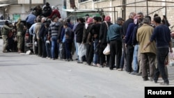 People line up for bread in Afrin, Syria, March 20, 2018.