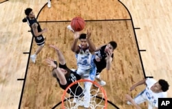 North Carolina's Isaiah Hicks (4) takes a shot during finals of the Final Four NCAA college basketball tournament against Gonzaga in April. North Carolina won. AP Photo/Chris Steppig, Pool)