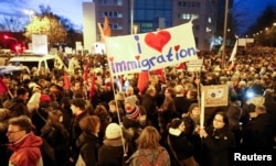 People gather to take part in a protest against the march of PEGIDA, a grassroots anti-Muslim movement, in Cologne, Jan. 5, 2015.
