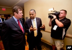 Donald Trump campaign chief Paul J. Manafort, left, chats with former presidential candidate Ben Carson as they head to a 'Trump for president reception' at the Republican National Committee Spring Meeting, April 21, 2016, in Hollywood, Florida.