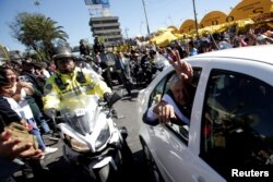 Mexico's Andres Manuel Lopez Obrador waves from his car while heading to National Palace in Mexico City, Dec. 1, 2018.