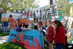 Protesters gather outside the Utah Governor's Energy Summit at Grand America Hotel, May 30, 2019, in Salt Lake City.