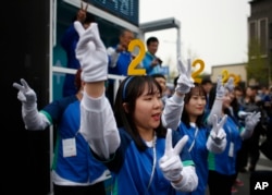 Supporters of the main opposition party, the Minjoo Party of Korea, cheer for their candidates during a campaign rally ahead of the April 13 parliamentary election in Seoul, South Korea, Tuesday, April 12, 2016.