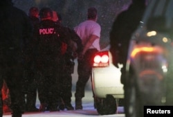 FILE - Police put the man suspected of killing at least three people during a shooting at a Planned Parenthood center in Colorado Springs, Colorado into a police vehicle, Nov. 27, 2015.