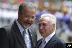 FILE - Brazil's President Michel Temer, right, talks with Defense Minister Raul Jungmann during his arrival to attend a meeting of the Defense Military Council, in Brasilia, Brazil, Feb. 22, 2018.