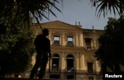 A policeman is seen outside the National Museum of Brazil in Rio de Janeiro, Brazil, Sept. 3, 2018.