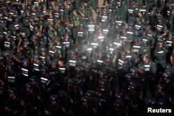 Cambodia's armed forces display anti-riot gear and assault rifles at the Olympic stadium ahead of a general election this weekend, in Phnom Penh, Cambodia, July 25, 2018.