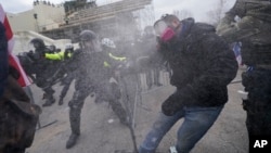 Trump supporters try to break through a police barrier, Wednesday, Jan. 6, 2021, at the Capitol in Washington. As Congress prepares to affirm President-elect Joe Biden's victory, thousands of people have gathered to show their support for President Donald