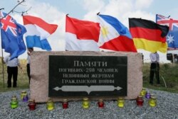 FILE - People attend a ceremony marking the fifth anniversary of the Malaysia Airlines Flight MH17 plane crash near Hrabove in Donetsk Region, Ukraine, July 17, 2019.