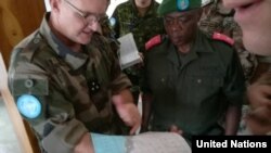 General Commis (MONUSCO) and General Kasereka (FARDC) refine the protection plan of the city of Uvira, near the Burundian border, on the northern end of Lake Tanganyika. (MONUSCO/Bilamekaso Tchagbele)