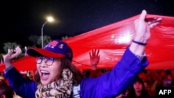 Supporters hoist a giant Taiwan national flag during a campaign rally of Kuomintang (KMT) ahead of Taiwan's presidential election, in Taipei, Taiwan, on Dec. 23, 2023.
