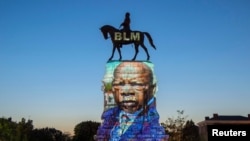 The image of late Rep. John Lewis, a pioneer of the civil rights movement and long-time member of the U.S. House of Representatives, is projected on the statue of Confederate General Robert E. Lee in Richmond, Virginia, July 19, 2020.