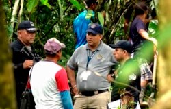 Police and employees of the Public Ministry investigate near a mass grave with seven bodies at the indigenous region of Ngabe Bugle, Panama, Jan. 15, 2020, in this screen grab taken from Panamanian channel TVN Noticias.