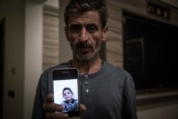 Syrian Kurd Yusf Hussein shows a photo of his son Muhammed, 13, who was killed by Turkish mortars in Turkey's incursion into northern Syria, in Sulaymaniyah, northern Iraq, Oct. 30, 2019. (Rebaz Majeed/VOA)