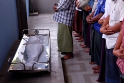 Muslim men pray during the funeral of 7 year-old girl Khin Myo Chit who was shot at her home during protests against military coup in Mandalay, Myanmar, March 24, 2021.