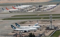 FILE - Cathay Pacific Airways and Dragon Airways planes are seen at the Hong Kong International Airport, Sept. 6, 2019.