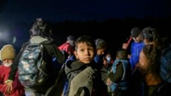 South American immigrants disembark from an inflatable boat on the U.S. bank of the Rio Grande river, on March 28, 2021.