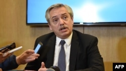FILE - Handout photo released by Argentinian presidential candidate for the "Frente de Todos" party Alberto Fernandez's press office of him speaking to the press in Buenos Aires, Aug. 14, 2019. 