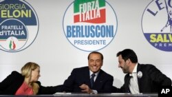 FILE - From left, Brothers of Italy's Giorgia Meloni, Forza Italia's Silvio Berlusconi, and the League's Matteo Salvini attend a media event for center-right leaders ahead of the March 4 general elections, in Rome, Italy, March 1, 2018. 