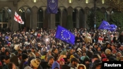 Supporters of Georgia's opposition attend a rally to protest after the government halted the EU application process until 2028, in Tbilisi, Nov. 28, 2024.