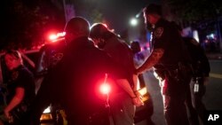A protestor is arrested near Barclays Center after a rally over the death of George Floyd, a black man who was in police custody in Minneapolis, on Friday, May 29, 2020, in the Brooklyn borough of New York. Floyd died after being restrained by…