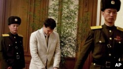 American student Otto Warmbier, center, arrives at the People's Cultural House, as Warmbier is presented to reporters Monday, Feb. 29, 2016.