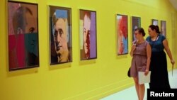 Visitors at Pera Museum in Istanbul look at artwork by Andy Warhol, June 10, 2014.