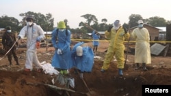 Volunteers and Congolese security officers dig in search for bodies of residents killed in an attack by suspected Islamist rebels at Masala, Democratic Republic of Congo, June 9, 2024. Authorities say the rebels struck again on June 13, killing at least 42 people.
