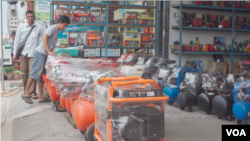 Two men are looking to buy electricity generators at a local shop in Phnom Penh, Cambodia, May 11, 2019. (Khan Sokummono/VOA Khmer) 