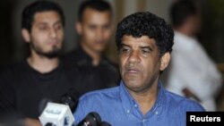 Abdullah Al-Senussi, head of the Libyan Intelligence Service speaks to the media in Tripoli August 21, 2011. 