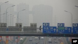 A man, holding a national flag with a poster of Turkey&#39;s founder Kemal Ataturk, watches as thousands of Turks clash with security as they try to break through barricades mounted around the prison and courthouse complex in Silivri, in the outskirts of Istanbul.
