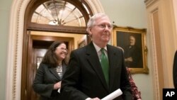 Senate Majority Leader Mitch McConnell, R-Ky., leaves the chamber after announcing an agreement in the Senate on a two-year, almost $400 billion budget deal, at the Capitol in Washington, Feb. 7, 2018. 
