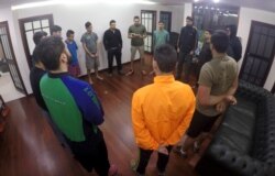 In this Nov. 8, 2019 photo, Venezuelan soldiers, who took part in a failed April rebellion against Nicolas Maduro, stand in a prayer circle inside Panama's Embassy in Caracas, Venezuela.