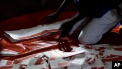 A polling agent counts the ballots during the Liberian presidential election at a polling station in Monrovia, Liberia, Oct. 10, 2017. 