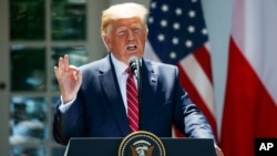 President Donald Trump answers reporter's question during a press conference at the White House in Washington. 